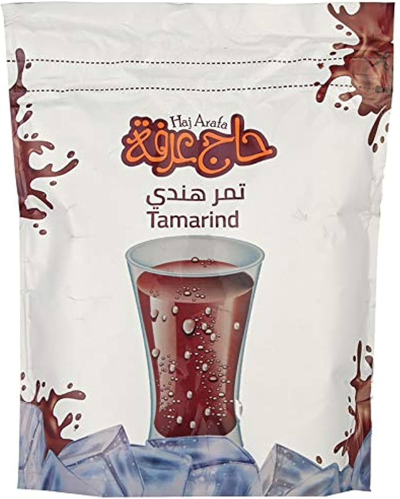 Haj Arala tamarind drink package with a glass of tamarind juice on a white background عصير تمر هندي